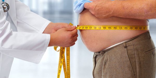 bigstock-doctor-measuring-obese-man-wai-110880518